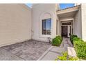 Welcoming entryway with custom brickwork, mature plants, and an attractive front door at 7006 E Jensen St # 33, Mesa, AZ 85207