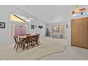 Bright dining room with large windows, offering natural light and comfortable dining space at 7538 E Forge Ave, Mesa, AZ 85208