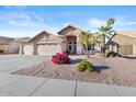 Attractive home boasting a 3-car garage, desert landscaping, and welcoming curb appeal at 7538 E Forge Ave, Mesa, AZ 85208