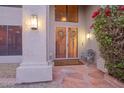 Inviting home entrance with decorative wreaths on the security doors and a beautiful stone porch at 802 N Butte Ave, Chandler, AZ 85226