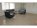 Living room with ample natural light, tile flooring, and modern furniture at 8219 N 59Th Ave, Glendale, AZ 85302