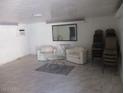 Clean living room with modern chairs, marble floors, and large mirror at 8219 N 59Th Ave, Glendale, AZ 85302