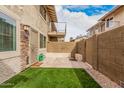 Private backyard featuring artificial grass, paved patio, and block wall for an intimate outdoor space at 8532 E Belleview St, Scottsdale, AZ 85257