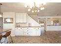 Dining area with white cabinetry, wood counters, stylish light fixture, and tile flooring at 1293 E Clifton Ave, Gilbert, AZ 85295