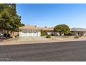 Attractive single-story home with a lush front yard and two-car garage at 13014 W La Terraza Dr, Sun City West, AZ 85375