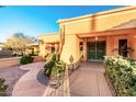 Inviting home entrance featuring desert landscaping, walkway, and secure double doors at 13317 W Serenade Cir, Sun City West, AZ 85375