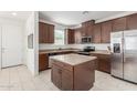 Modern kitchen featuring stainless steel appliances, ample cabinet space, and a center island for food preparation at 14870 W Encanto Blvd # 1008, Goodyear, AZ 85395