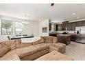 Open-concept living space with a comfortable sectional sofa and a seamless transition to the dining and kitchen areas at 14870 W Encanto Blvd # 1008, Goodyear, AZ 85395