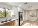 Updated kitchen has stainless steel appliances, a window, and light wood-look floors at 15050 N Thompson Peak Pkwy # 2036, Scottsdale, AZ 85260