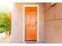 Close-up of a warm brown front door with the house number and natural sunlight at 15221 N Clubgate Dr # 2012, Scottsdale, AZ 85254