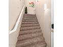 Carpeted staircase with a white handrail and a modern wall sconce at 15221 N Clubgate Dr # 2012, Scottsdale, AZ 85254