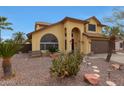 Landscaped front yard with desert plants and a rock lawn, leading to an inviting entrance at 15237 N 61St Dr, Glendale, AZ 85306