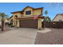 Beautiful two-story home with a two-car garage, complemented by desert landscaping at 15237 N 61St Dr, Glendale, AZ 85306