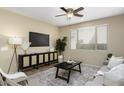 Inviting living room boasts a ceiling fan, area rug, and comfortable seating area at 1783 W Homestead Dr, Chandler, AZ 85286