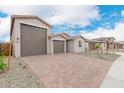 A neighborhood view of the house showing the driveway and other similar houses in the neighborhood at 18667 E Panchito Dr, Gold Canyon, AZ 85118