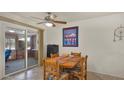 Cozy dining area adjacent to a sliding glass door offering natural light and outdoor access at 19827 N 101St Ave, Sun City, AZ 85373