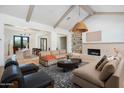Open-concept living room with vaulted ceilings, fireplace, and stylish decor, creating an inviting space at 220 E Georgia Ave, Phoenix, AZ 85012