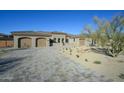 Beautiful home with a paver driveway and lush desert landscaping at 23964 N 128Th Pl, Scottsdale, AZ 85255