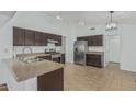 Bright kitchen featuring stainless steel appliances, dark cabinetry, and a functional layout at 2444 S Terrell --, Mesa, AZ 85209