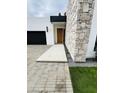 Modern home entrance highlighting stone accent wall and clean, geometric design at 3106 N Valencia Ln, Phoenix, AZ 85018