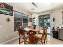 Dining room features wood table, pendant lighting, and sliding glass doors at 36579 W Barcelona Ln, Maricopa, AZ 85138