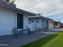 Attractive single-story home with manicured lawn and updated gray exterior paint and garage door at 4007 W Rue De Lamour Ave, Phoenix, AZ 85029