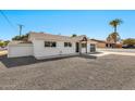 A white painted single story home with minimalist landscaping at 455 E Garfield St, Tempe, AZ 85288