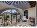 Enclosed front porch, archway entry, covered seating area with a view of the neighborhood at 4828 E Capistrano Ave, Phoenix, AZ 85044