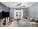 Cozy living room with a mounted TV, stylish console, comfortable sofa, and access to the outdoor patio at 5995 N 78Th St # 1063, Scottsdale, AZ 85250