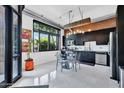 Bright kitchen with black cabinets, stainless steel appliances, industrial accents and large windows at 7301 E 3Rd Ave # 121, Scottsdale, AZ 85251