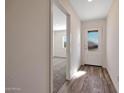 Inviting entryway featuring wood-look floors, a glass-paneled door, and a view into the living area at 1082 W 20Th St, Florence, AZ 85132