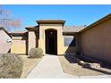 Inviting front entrance with a covered porch, desert landscaping, and a well-maintained walkway at 10916 E Cholla Rd, Mesa, AZ 85207