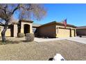 Attractive single-story home featuring desert landscaping and a covered entryway at 10916 E Cholla Rd, Mesa, AZ 85207