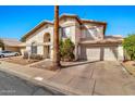 View of the home exterior, with an attached two car garage, a tile roof, and desert landscaping at 1150 E Liberty Shores Dr, Gilbert, AZ 85234