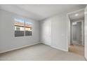 Bright bedroom with a large window, neutral carpet, and a closet at 13538 W Calle De Baca --, Peoria, AZ 85383