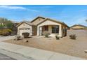Charming single-story home with low-maintenance front yard and attached two-car garage at 1358 E Angie St, Casa Grande, AZ 85122