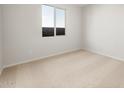 Bright bedroom with neutral carpet, large window, and fresh white walls at 13769 W Whisper Rock Trl, Peoria, AZ 85383