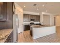 Kitchen with granite countertops, stainless steel appliances, and dark wood cabinets at 15032 W Gray Fox Trl, Surprise, AZ 85387
