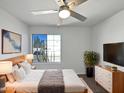 Comfortable main bedroom with a large window, ceiling fan, and neutral decor at 15420 S 29Th St, Phoenix, AZ 85048