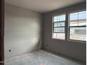 Bedroom under construction with two windows providing natural light, offering a blank canvas for customization at 15768 W Beryl Ave, Waddell, AZ 85355