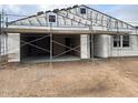 Unfinished exterior of a home with an attached two-car garage, showcasing the building's construction phase at 15768 W Beryl Ave, Waddell, AZ 85355