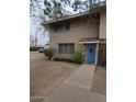 Charming two-story brick home with a blue front door and well maintained front yard at 1652 W Campbell Ave, Phoenix, AZ 85015
