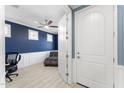View from hallway into office with blue walls and a door to a main living area at 20408 E Rosa Rd, Queen Creek, AZ 85142