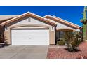 Charming single-story home with a two-car garage and desert landscaping at 2120 E Daley Ln, Phoenix, AZ 85024