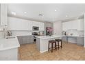 Well-lit kitchen boasts two-tone cabinets, modern stainless steel appliances, and a center island at 2129 E Leo Pl, Chandler, AZ 85249