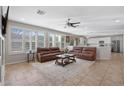 Cozy living room featuring tile floors, plantation shutters, and an open concept design at 2129 E Leo Pl, Chandler, AZ 85249