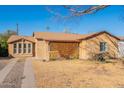 This cozy home has mature landscaping and a lattice-covered porch, adding curb appeal at 2318 E Flower St, Phoenix, AZ 85016