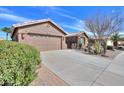 The home has a neutral exterior color, a large driveway, and desert landscaping at 2408 E Fiesta Dr, Casa Grande, AZ 85194