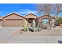 Beautiful desert landscaping with cacti and stone accents adorn the front yard at 2408 E Fiesta Dr, Casa Grande, AZ 85194