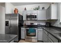 Well-equipped kitchen featuring stainless steel appliances, gray cabinets, and stylish backsplash at 2910 W Allens Peak Dr, San Tan Valley, AZ 85144